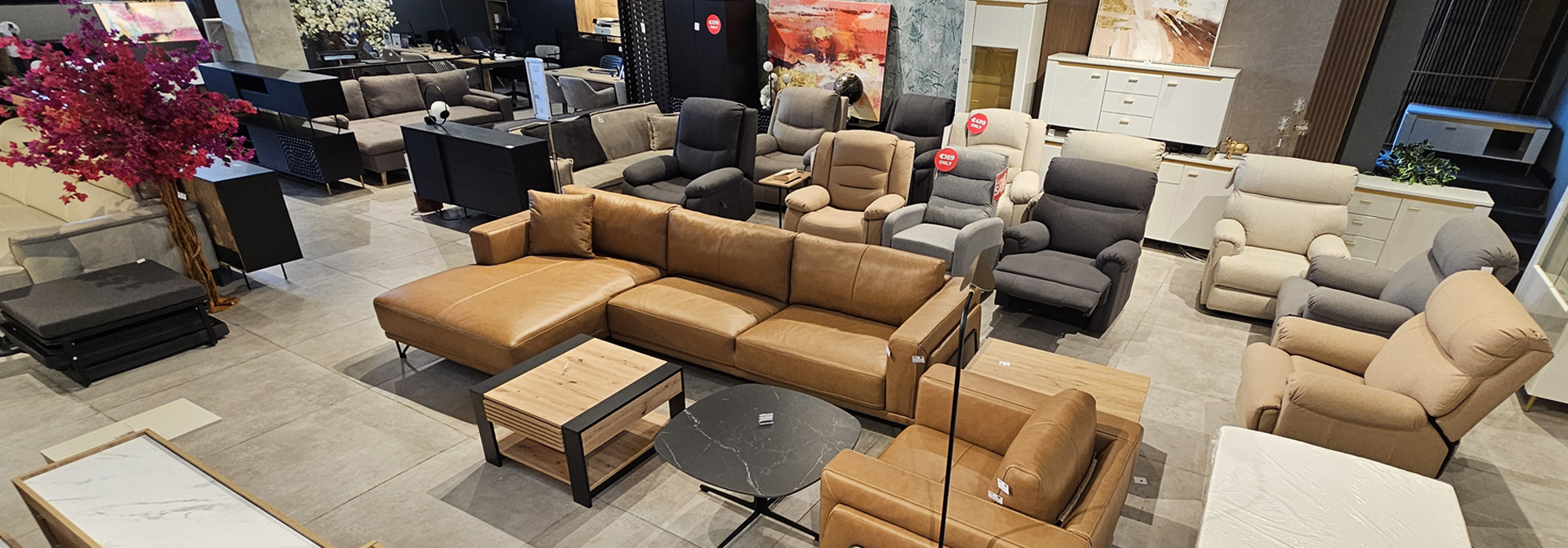 OK Home showroom floor with leather sectional sofa and multiple fabric recliners.
